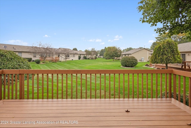 wooden terrace with a lawn