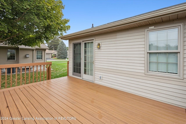 wooden deck with a lawn