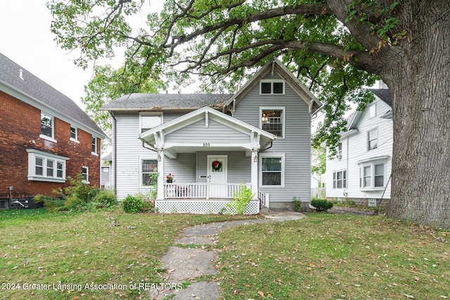 view of front of home featuring a porch and a front yard