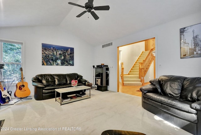 living room featuring light colored carpet, ceiling fan, and lofted ceiling