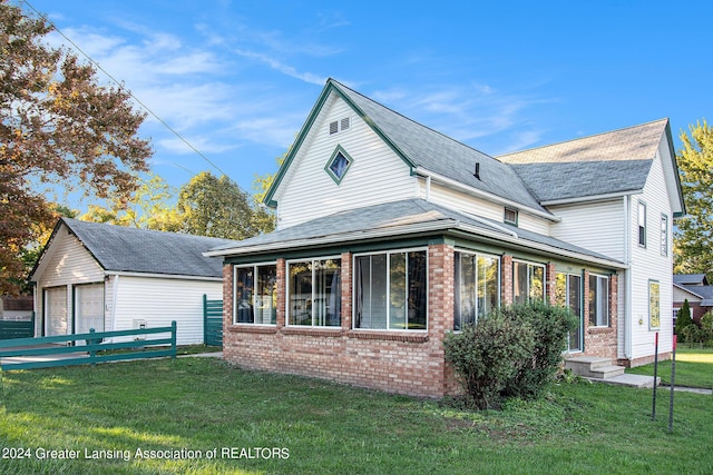 318 S Shiawassee St, Corunna, MI 48817 - view of home's exterior featuring brick siding, a garage, an outdoor structure, and entry steps
