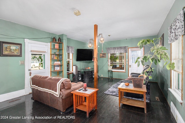 living room featuring lofted ceiling and dark wood-type flooring