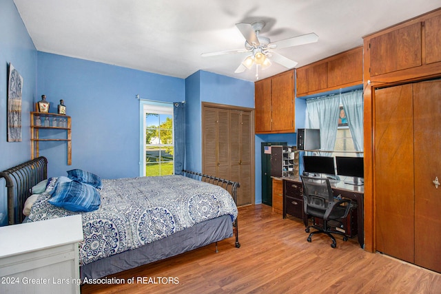 bedroom with ceiling fan, light hardwood / wood-style flooring, and a closet