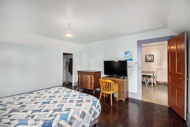 bedroom with lofted ceiling and dark hardwood / wood-style flooring