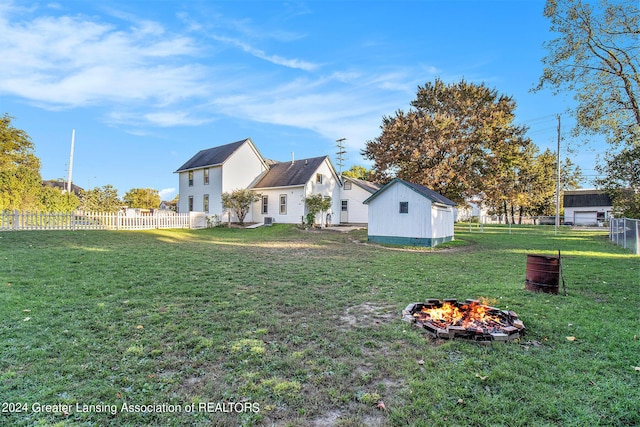 318 S Shiawassee St, Corunna, MI 48817 - back of property with an outdoor fire pit, a fenced backyard, and a shed