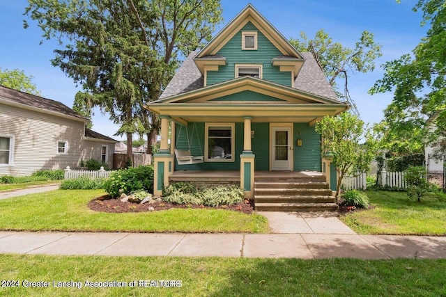 view of front of house with a front lawn and a porch