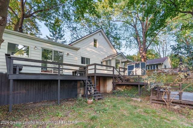 back of property with a wooden deck