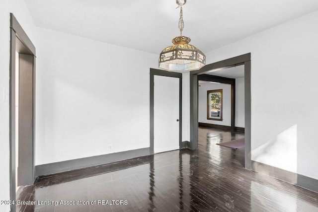 spare room with dark wood-type flooring