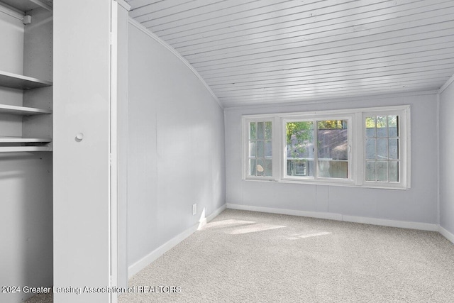 interior space featuring crown molding, lofted ceiling, carpet floors, and wood ceiling