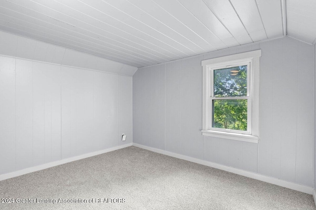 bonus room with carpet flooring and vaulted ceiling