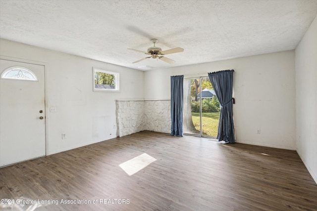 spare room with ceiling fan, hardwood / wood-style flooring, and a textured ceiling