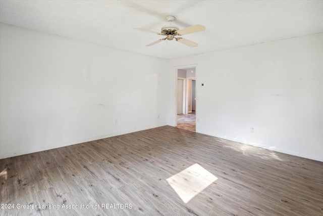 spare room with light wood-type flooring and ceiling fan