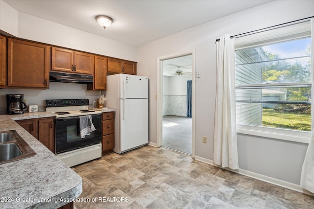 kitchen with white appliances, sink, ceiling fan, and a wealth of natural light