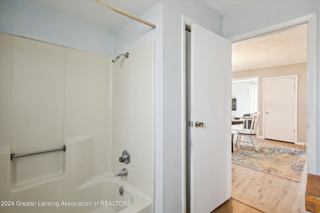 bathroom featuring shower / bathtub combination and hardwood / wood-style flooring