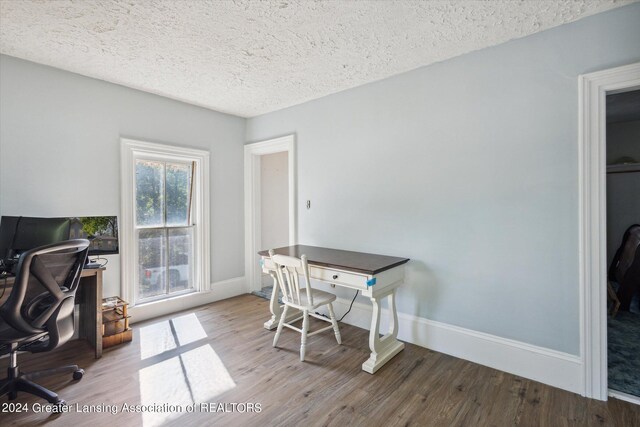 office with a textured ceiling and hardwood / wood-style floors