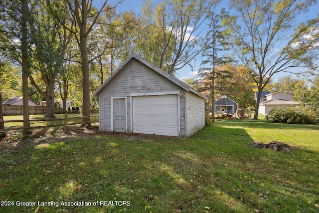 garage featuring a lawn