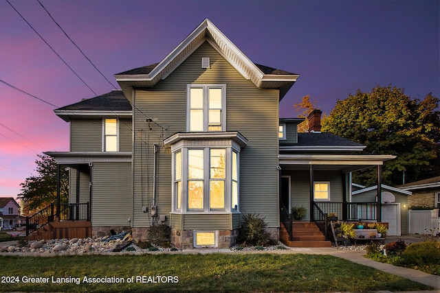 view of front of house featuring a yard and a porch