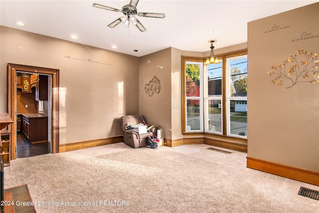 unfurnished room with carpet and ceiling fan