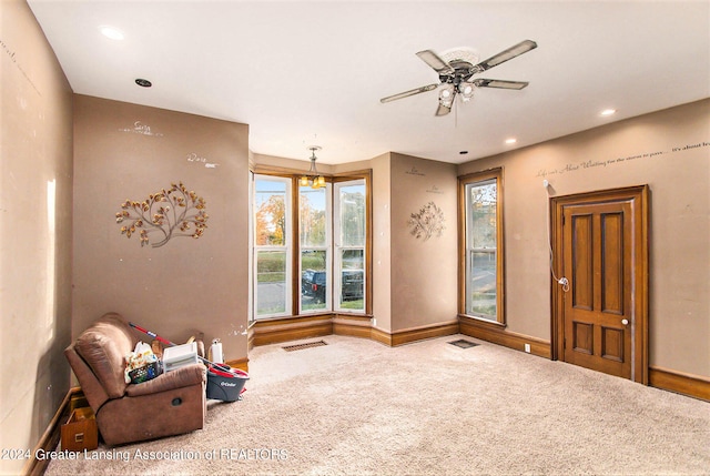 sitting room with carpet floors and ceiling fan