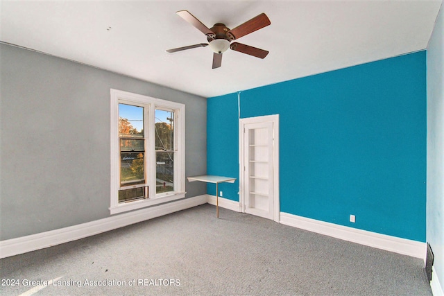 unfurnished room with ceiling fan and carpet floors