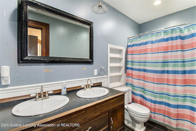 bathroom with vanity, toilet, and walk in shower