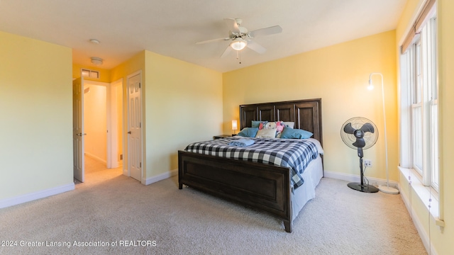 carpeted bedroom with ceiling fan