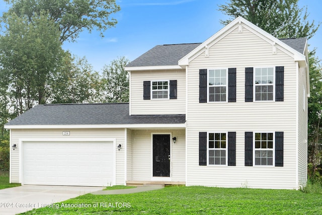 view of front property featuring a garage and a front yard