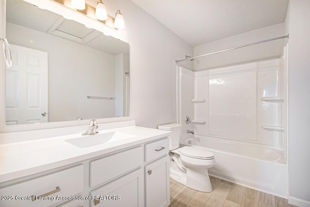 full bathroom featuring vanity, hardwood / wood-style flooring, toilet, and shower / bath combination