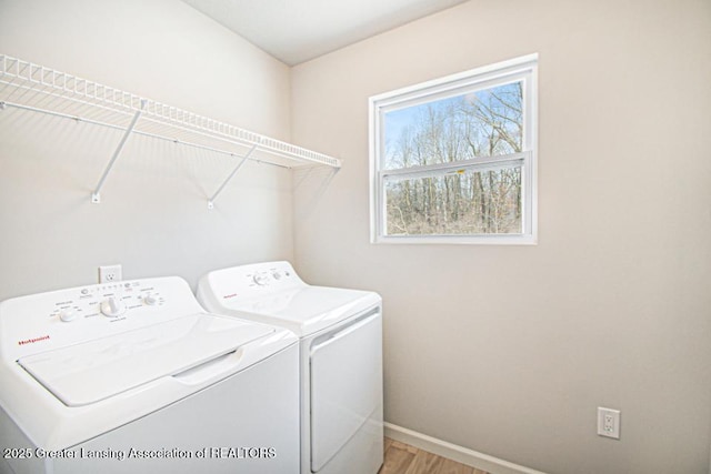 washroom featuring wood-type flooring and washing machine and clothes dryer