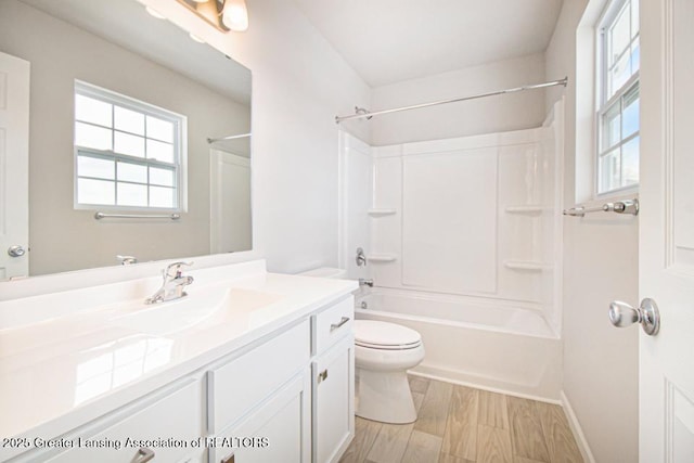 full bathroom with vanity, hardwood / wood-style floors, shower / washtub combination, and toilet