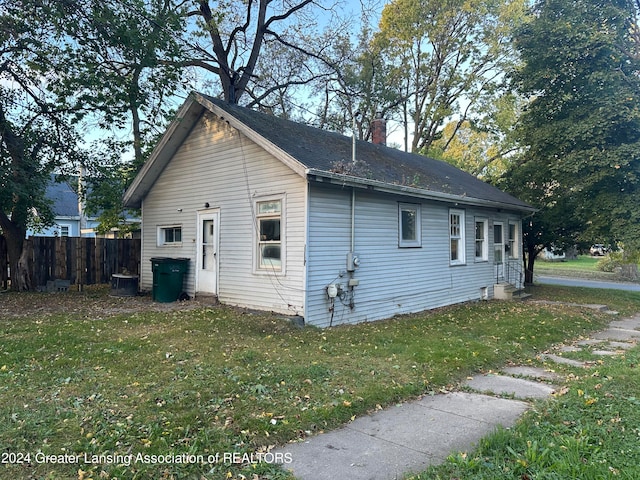 view of side of home featuring a yard