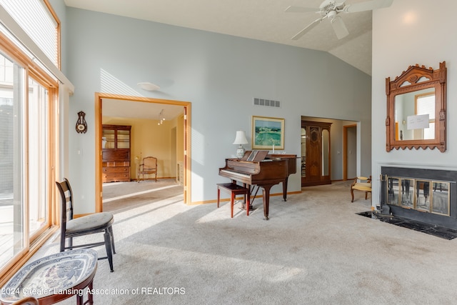 interior space with high vaulted ceiling, ceiling fan, and light colored carpet