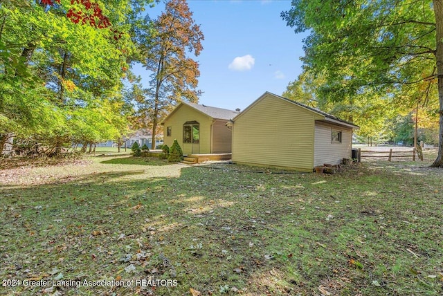 view of property exterior with a lawn