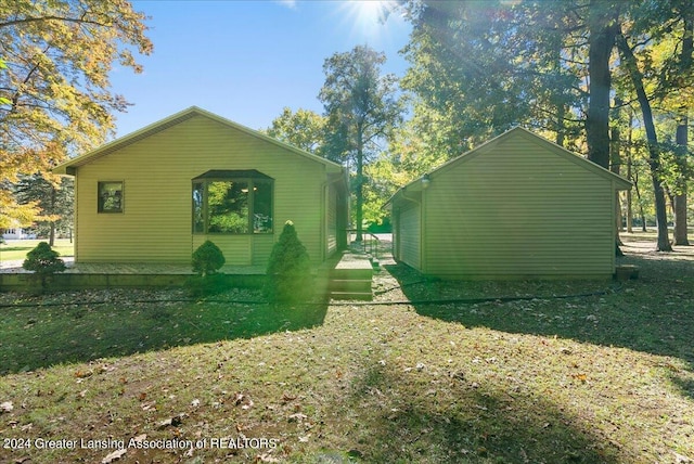 view of side of home with a yard