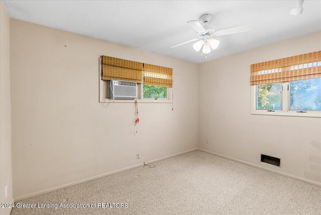 carpeted empty room with cooling unit and ceiling fan