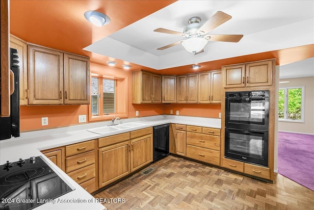 kitchen with parquet flooring, ceiling fan, black appliances, and sink