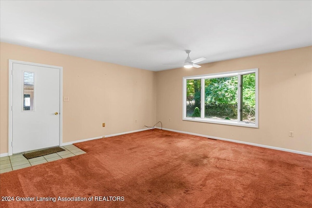 empty room with light carpet and ceiling fan