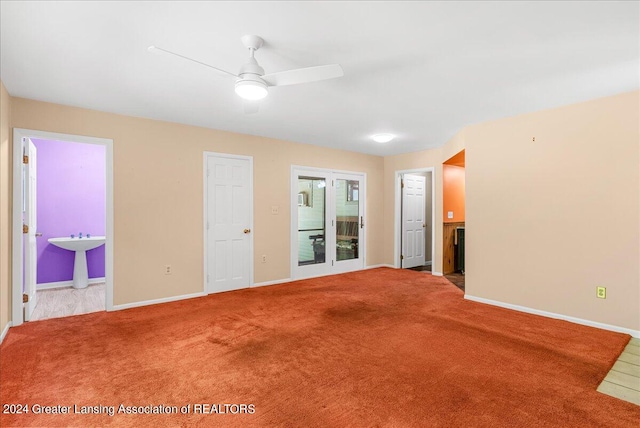 unfurnished room featuring sink, carpet, and ceiling fan