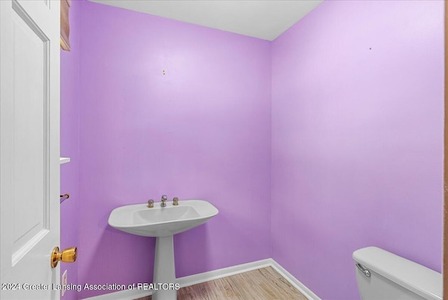 bathroom featuring toilet and hardwood / wood-style flooring