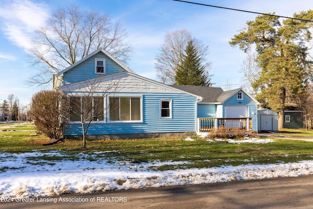 view of front of house featuring a yard and a storage unit