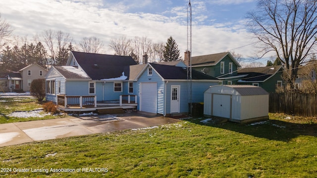 back of property featuring a lawn, a storage shed, and a wooden deck