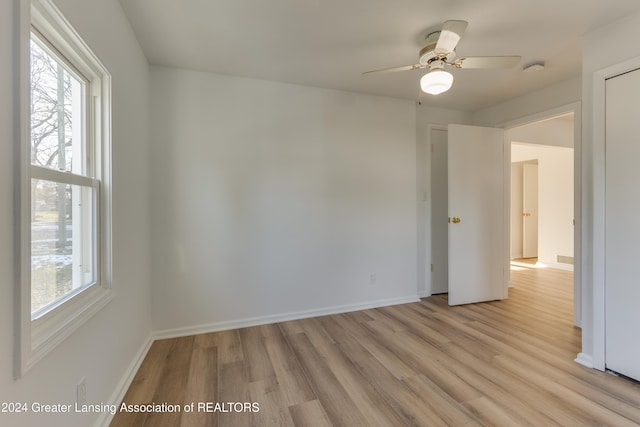 unfurnished room featuring ceiling fan and light wood-type flooring