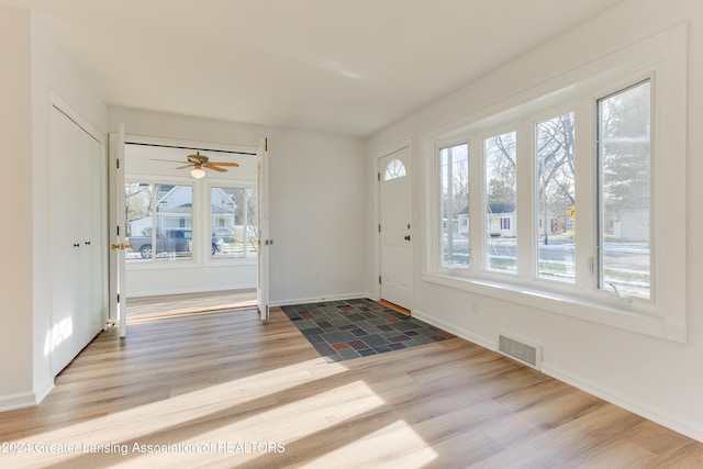 entrance foyer with ceiling fan and light hardwood / wood-style flooring