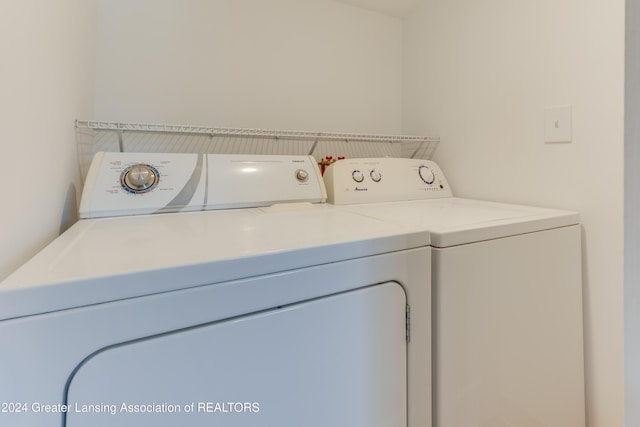 clothes washing area with separate washer and dryer