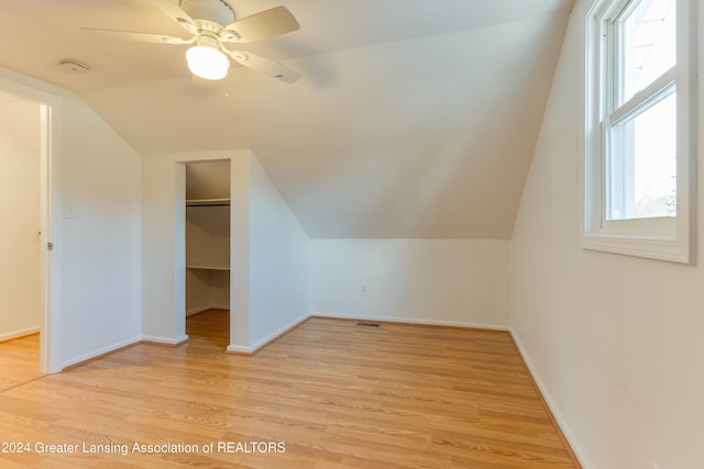 bonus room with light wood-type flooring, vaulted ceiling, and ceiling fan