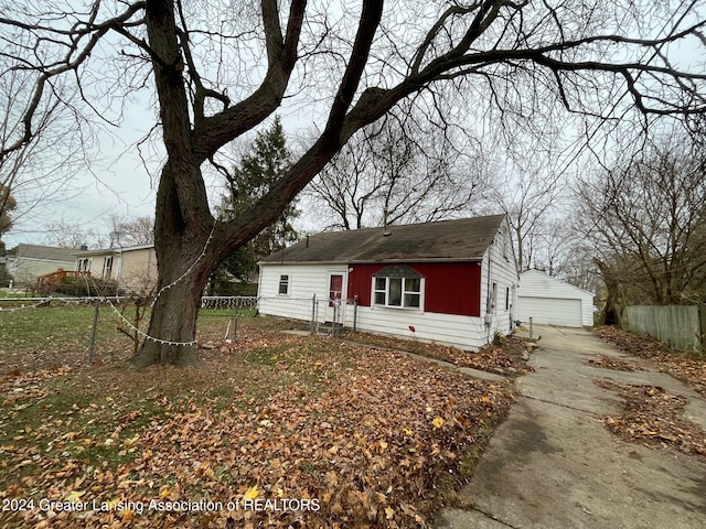 view of front of home with a garage and an outdoor structure