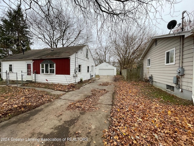 view of home's exterior with a garage and an outdoor structure