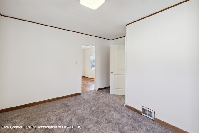 carpeted empty room with ornamental molding