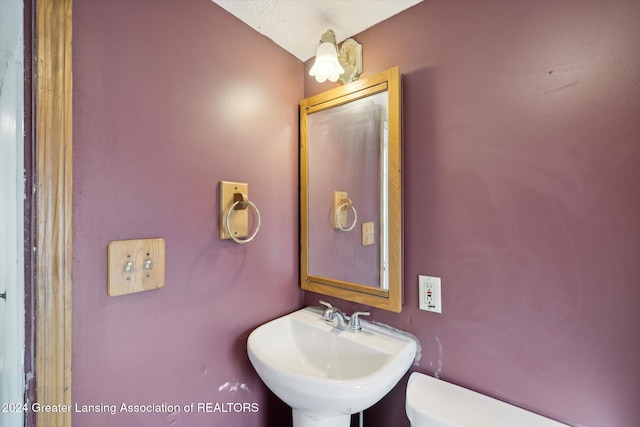 bathroom featuring sink and toilet