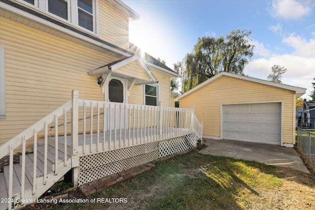 deck featuring a garage and an outbuilding